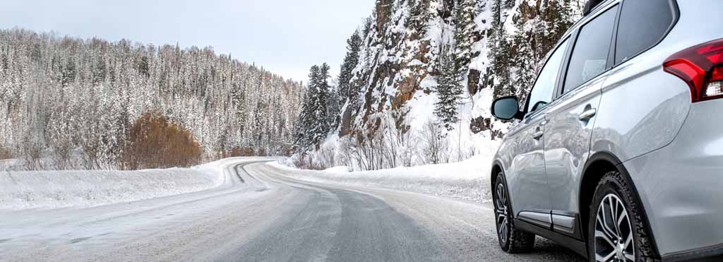 silver car driving on winter road