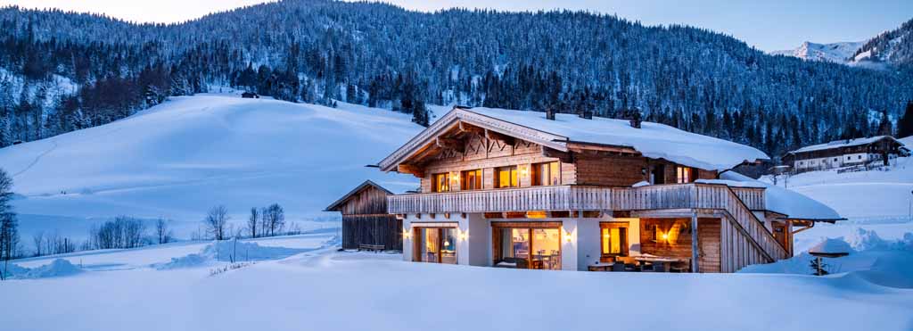 cabin home surrounded by snow